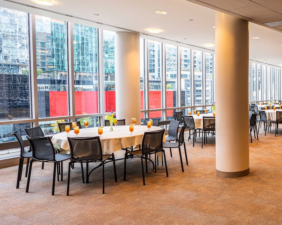 View of the Medium North Lounge at the Gleacher Center with a wide open space with tables along a window on the side