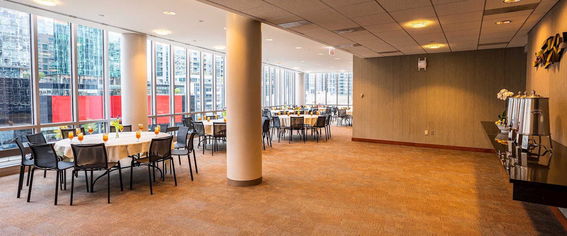 View of the Medium North Lounge at the Gleacher Center with a wide open space with tables along a window on the side