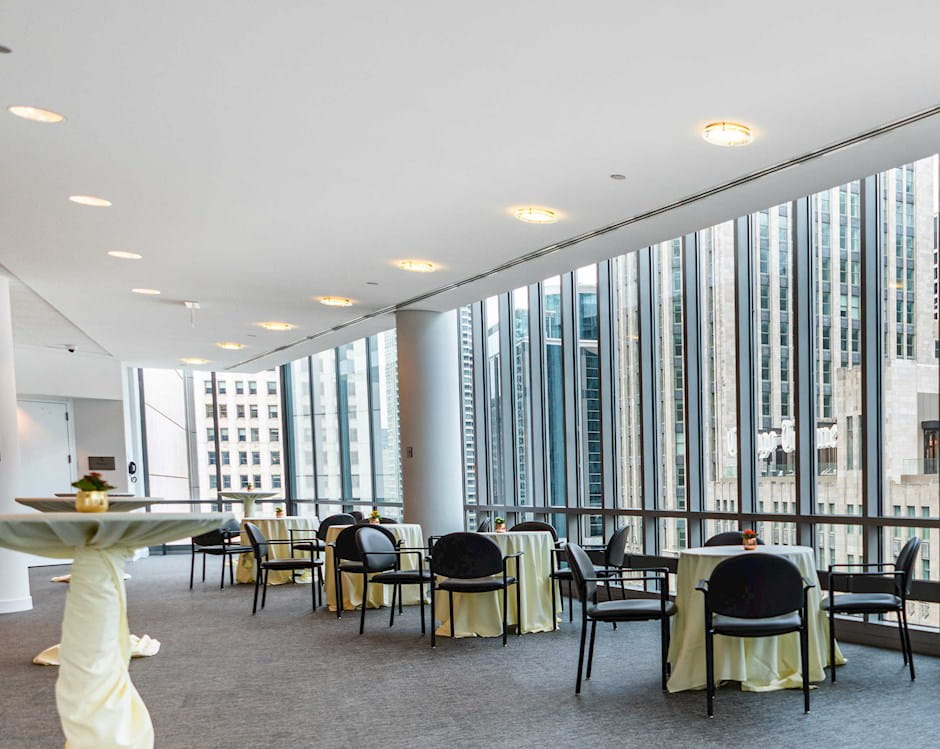 Gleacher Center reception room with bar and tables overlooking Chicago skyline